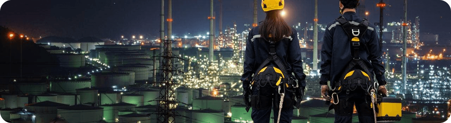 Workers on construction site overlooking city lights